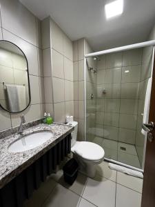 a bathroom with a toilet and a sink and a shower at Natal Suites - PontaNegra in Natal +21 photos
