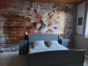 a bedroom with a bed with flowers on the wall at Domaine la belle charentaise in Chadenac +87 photos