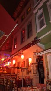 a building with lights on the side of it at night at Paxx Istanbul Hotel&Hostel in Istanbul +26 photos