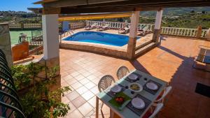 una vista sul soffitto di un patio con tavolo e piscina di Casa Amparo Casitas Select a Frigiliana
