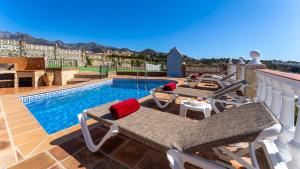 una piscina con due sedie e un tavolo sul balcone di Casa Amparo Casitas Select a Frigiliana Altre 24 foto