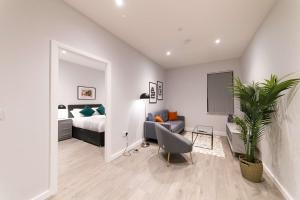 a bedroom with a bed and a couch and a chair at Convenient 2 Bed Apartment in Waterloo Liverpool in Waterloo