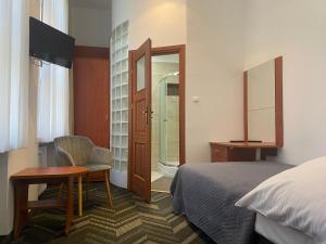 a hotel room with a bed and a table and a chair at Rewita Rogowo k Kołobrzegu in Rogowo +111 photos