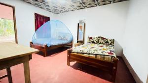 Postel nebo postele na pokoji v ubytování Sigiri Elephants Path Hostel