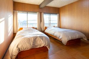 南アルプス市にあるいますわの宿の窓が2つある部屋にベッドが2つある