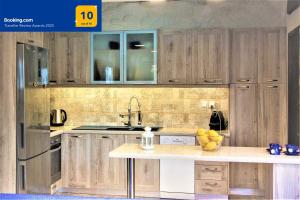 a kitchen with wooden cabinets and a counter top at Private Beachfront House Irene Mare, Serene Views in Poros +42 photos