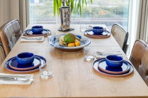 a wooden table with a bowl of fruit on it at Waterview apartments with ultra fast wifi close to Excel and O2, corporates and contractors welcome in London