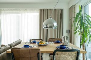a dining room table with a bowl of fruit on it at Waterview apartments with ultra fast wifi close to Excel and O2, corporates and contractors welcome in London