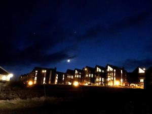 a row of houses at night with the moon in the sky at Heimasta Horn in Tórshavn