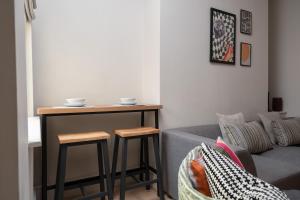 a living room with a table and a couch at Charlottes Place in Liverpool +19 photos
