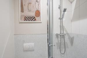 a shower with a glass door in a bathroom at Charlottes Place in Liverpool