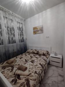 a bedroom with a bed and a dresser in it at Bulevar Apartman BL in Banja Luka