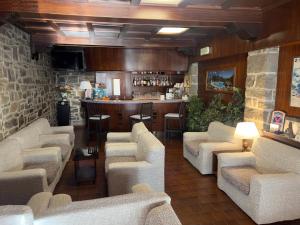 a lobby with couches and a bar in a restaurant at Hotel Montegrande in Vidiciatico