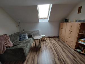 a living room with a couch and a table at Tygiel Krzywa, Beskid Niski in Krzywa