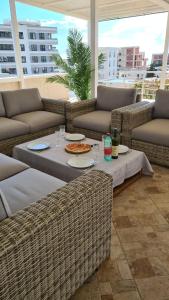 a patio with couches and a table with a pizza on it at Villa Sunshine in Bar