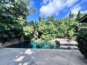 a swimming pool in a garden with trees at Destination #08 in Anaheim