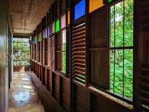 a hallway with stained glass windows in a building at โรงแรมเฮือนช้างเผือก Huen Chang Phueak in Nan