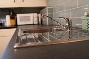 a kitchen counter with a sink and a microwave at Número 8 a Traditional Basque Village Homestead in Laguardia +41 photos