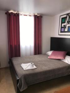 a bedroom with a bed with a napkin on it at HOTEL Destino Nómada Calle 11 n 1-38 in Bogotá