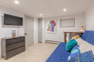a living room with a blue bed and a flat screen tv at DC colorful place plus Free Parking in Washington