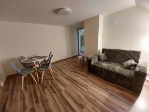 a living room with a couch and a table and chairs at Tygiel Krzywa, Beskid Niski in Krzywa