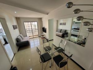 a living room with a glass table and chairs at Spazio Bella Vita · Bela vista em Águas Claras in Brasilia
