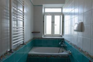a bath tub in a bathroom with a window at Casa Vacanze Residenziale in Naples