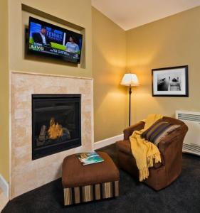 uma sala de estar com lareira e uma televisão de ecrã plano em Monterey Peninsula Inn em Pacific Grove