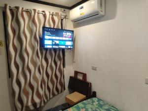 a room with a flat screen tv on the wall at Diaz Residence in Silang