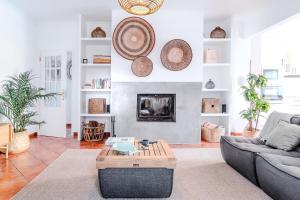 a living room with a couch and a fireplace at Villa in Comporta Village with heated pool in Comporta