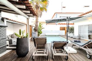 a patio with a pool and chairs and a table at Villa in Comporta Village with heated pool in Comporta
