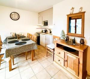 a kitchen with a table and a sink in it at Chalet Joue du loup 6-7 pers in Le Dévoluy
