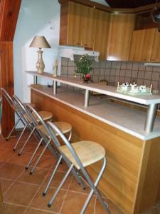 a kitchen with four chairs at a counter at Centralt i Gevgelija in Gevgelija