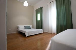 Postel nebo postele na pokoji v ubytování Lues Rooms
