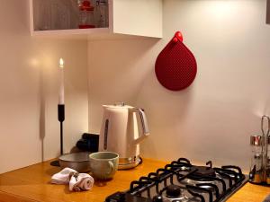 a kitchen counter with a stove top and a coffee maker at Nama Boutique Residence in Venice