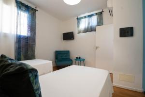 Postel nebo postele na pokoji v ubytování Lues Rooms