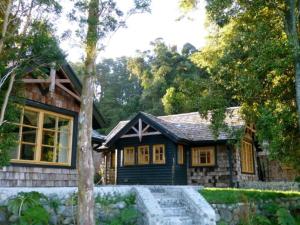a small house with a stone path in front of it at Cabañas Quebrada Verde in Puerto Varas