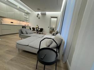 a living room with a couch and a table at Rambynas R36 SELF CHECK-IN in Panevėžys