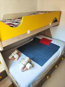 a bunk bed with two dolls on the bottom bunk at Enjoy the beach in Bellreguart +43 photos