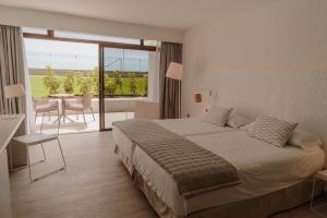 a hotel room with a bed and a balcony at Don Gregory by Dunas - Adults Only in San Agustin