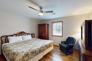 a bedroom with a bed and a blue chair at The Cozy Corner in Bentonville
