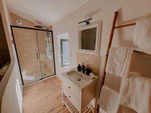 a bathroom with a sink and a shower at La Maison Des Pierres Blondes in Orban +24 photos