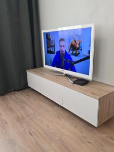 a television sitting on top of a dresser at Like home, Coffee or Tea & Parking free in Trnávka
