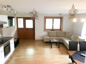 a living room with a couch and a table at Haus Elvira in Klösterle