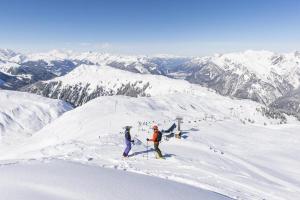 two people standing on top of a snow covered mountain at Haus Elvira in Klösterle