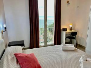 a bedroom with a bed with a view of the ocean at Vista Mare WI-FI AC P BBQ in Porto Palo