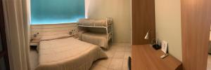 a small room with a bed and a desk at Il Giardino della Torre in Torre Maggiore