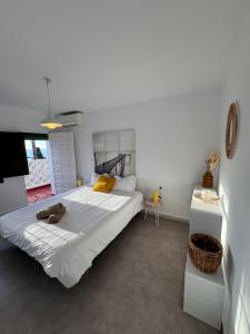 a bedroom with a large white bed in a room at La Chinita in Nerja