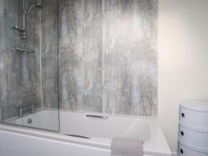 a bathroom with a shower and a bath tub at 19 Parc Delfryn in Brynteg +33 photos