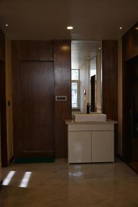 un baño con lavabo y espejo en Aayaan Roy villa, en Manali